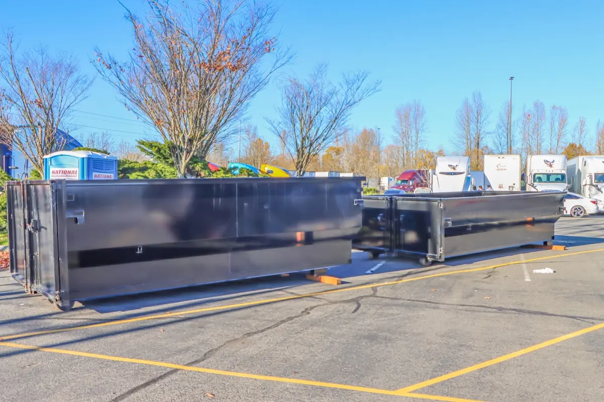 Professional dumpster rental service with roll-off container on residential driveway in North Myrtle Beach